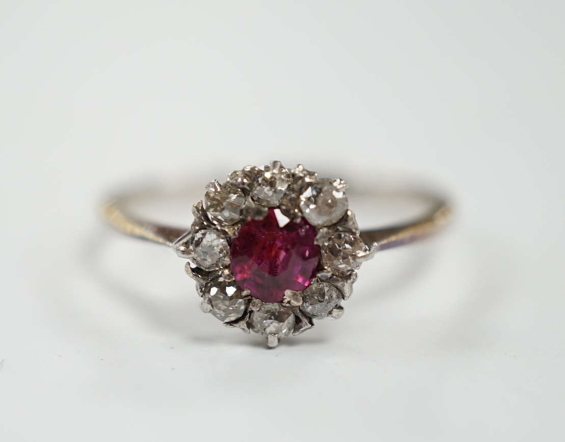 A 1940's 18ct white metal, ruby and diamond set circular cluster ring, size N/O, gross weight 1.9 grams. Condition - fair